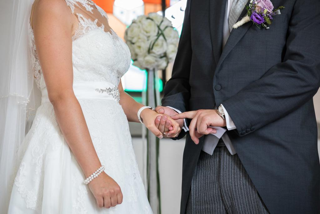 Bräutigam streichelt seiner Frau über die Hand.